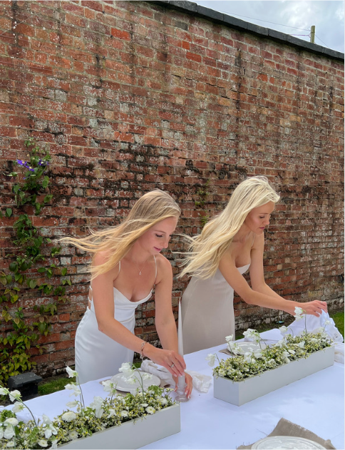 two event planners setting up luxury table scaping